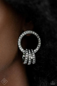 A commanding collection of silver hoops, adorned in glitzy white rhinestones, coalesces into an interlocking hoop display, creating a brilliantly stacked lure. The larger hoop the three smaller hoops adorn is also framed in glitzy white rhinestones, emitting glitz and glam from every curve. Earring attaches to a standard post fitting.  Sold as one pair of post earrings.