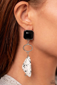 A black acrylic square, pressed in a sleek silver fitting gives way to an airy silver oval. An asymmetrical white stone triangle, featuring a black spotted motif, swings from the airy oval, adding artisanal movement to the high-end earthy display. Earring attaches to a standard post fitting. As the stone elements in this piece are natural, some color variation is normal.  Sold as one pair of post earrings.