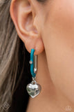 Featuring a solitaire white rhinestone embellishment, a silver heart charm swings from a glistening half turquoise-painted oblong silver hoop, creating a vivacious, charming display. Earring attaches to a standard post fitting. Hoop measures approximately 1" in diameter.  Sold as one pair of hoop earrings.