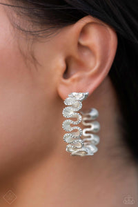 Meticulously dotted with white rhinestones, white pearlescent-painted ribbons playfully gather around the ear for an elegant display. Earring attaches to a standard post fitting. Hoop measures approximately 1 1/2" in diameter.  Sold as one pair of hoop earrings.