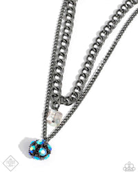 A mismatched curb and classic gunmetal chain layer down the chest. A chiseled, see-through, iridescent acrylic bead dangles from the bottom of the uppermost chain, while a sparkly blue UV rhinestone-encrusted gunmetal ornament swings from the lowermost chain for a galactic finish. Features an adjustable clasp closure. Due to its prismatic palette, color may vary.  Sold as one individual necklace. Includes one pair of matching earrings. 