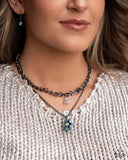 A mismatched curb and classic gunmetal chain layer down the chest. A chiseled, see-through, iridescent acrylic bead dangles from the bottom of the uppermost chain, while a sparkly blue UV rhinestone-encrusted gunmetal ornament swings from the lowermost chain for a galactic finish. Features an adjustable clasp closure. Due to its prismatic palette, color may vary.  Sold as one individual necklace. Includes one pair of matching earrings. 