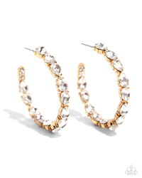 The front of a bold gold hoop is encrusted in glittery white rhinestones, creating a glamorous pop of sparkle. Earring attaches to a standard post fitting. Hoop measures approximately 2" in diameter.  Sold as one pair of hoop earrings.