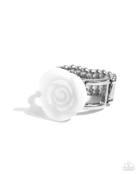 Featured in the center of an airy silver band, a white rosette is formed from shiny shell petals for a blooming basic atop the finger. Features a stretchy band for a flexible fit.  Sold as one individual ring.