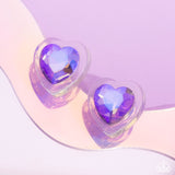 Featuring a faceted finish, a thick clear frame gathers around a purple UV shimmery heart center, creating a romantic display. Earring attaches to a standard post fitting.  Sold as one pair of post earrings.