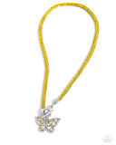 Embellished in yellow rhinestones, a mesh chain loops around the neckline, connecting through a silver toggle clasp. A yellow and iridescent-encrusted airy silver butterfly flutters below the yellow chain for a whimsically light finish. Features a toggle clasp closure. Due to its prismatic palette, color may vary.  Sold as one individual necklace. Includes one pair of matching earrings.