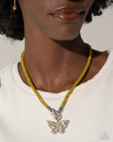 Embellished in yellow rhinestones, a mesh chain loops around the neckline, connecting through a silver toggle clasp. A yellow and iridescent-encrusted airy silver butterfly flutters below the yellow chain for a whimsically light finish. Features a toggle clasp closure. Due to its prismatic palette, color may vary.  Sold as one individual necklace. Includes one pair of matching earrings.