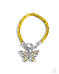 Embellished in yellow rhinestones, a mesh chain loops around the wrist, connecting through a silver toggle clasp. A yellow and iridescent-encrusted airy silver butterfly flutters below the yellow chain for a whimsically light finish. Features a toggle clasp closure. Due to its prismatic palette, color may vary.  Sold as one individual bracelet.