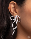 White-painted metal bows loop and curl below the ear for a girly, genuine display. Earring attaches to a standard clip-on fitting.  Sold as one pair of clip-on earrings.