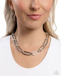 Twisted, textured rectangular silver rods in varying sizes interlock and layer around the neckline for a timelessly technical display. Features an adjustable clasp closure.  Sold as one individual necklace. Includes one pair of matching earrings.