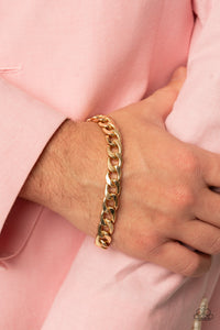 A thick gold strand of curb chain drapes around the wrist for a bold industrial look. Features an adjustable clasp closure.  Sold as one individual bracelet.   Get The Complete Look! Necklace: "Knockout Champ - Gold" (Sold Separately)