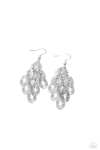 Dizzyingly layered oval silver frames swing from interlocking silver links, creating a twinkly movement as it flutters from the ear. Earring attaches to a standard fishhook fitting.  Sold as one pair of earring