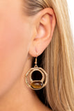 An oval tiger's eye stone is pressed into the bottom of a layered geometric gold frame radiating with hammered texture, resulting in an earthy and edgy trinket. Earring attaches to a standard fishhook fitting.   Sold as one pair of earrings