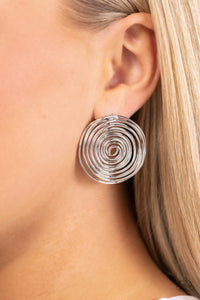 Shiny silver bars delicately bend and coil into a springy spiral, creating a dizzying frame. Earring attaches to a standard post fitting.  Sold as one pair of post earrings.