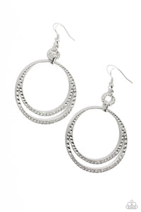 Dainty white rhinestones sparkle along the bottoms of a hammered silver hoop that splits into glistening layers, creating a glamorous effect. Earring attaches to a standard fishhook fitting.  Sold as one pair of earrings.