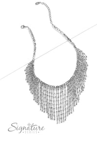 A collection of small, faceted beads is threaded along an invisible wire, showcasing their irresistible metallic shimmer and range of opacities. Dainty silver chain links, dotted with more of the same faceted beads, drip from the bowing strand, falling into a tapered fringe that flickers and flashes. Features an adjustable clasp closure.  Sold as one individual necklace. Includes one pair of matching earrings.