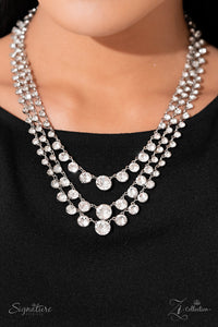 Rows of glittery, white rhinestones drape between two sleek silver bars, falling into three luxurious layers. The sparkling gems gradually increase in size as they fall towards the center of the design, adding dazzling dimension to the twinkling tiers. Features an adjustable clasp closure.  Sold as one individual necklace. Includes one pair of matching earrings.