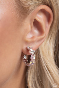 Tiny light pink iridescent flowers connect to one another as they wrap around the ear to create a charming, dainty hoop. Earring attaches to a standard post fitting. Hoop measures approximately 3/4" in diameter. Due to its prismatic palette, color may vary.  Sold as one pair of hoop earrings.