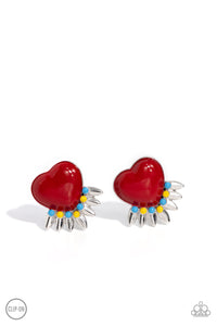 A red heart pressed in a sleek silver frame stands out at the ear. Textured silver leaves flare out from a curved cluster of turquoise and yellow beads that adorn the bottom of the heart display, creating a spring-inspired fringe. Earring attaches to a standard clip-on fitting.  Sold as one pair of clip-on e