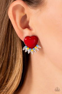 A red heart pressed in a sleek silver frame stands out at the ear. Textured silver leaves flare out from a curved cluster of turquoise and yellow beads that adorn the bottom of the heart display, creating a spring-inspired fringe. Earring attaches to a standard clip-on fitting.  Sold as one pair of clip-on e