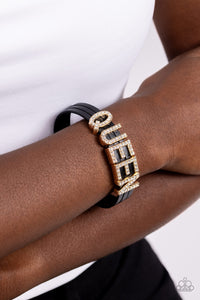 <p>Featuring glistening white rhinestones, gold letter frames forming the word "QUEEN" are threaded along layers of black leather strands around the wrist for a dazzling statement. Features a magnetic closure.</p> <p><i>Sold as one individual bracelet.</i></p>