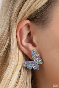 Featuring a tilted motif, a silver butterfly encrusted with an explosion of blue iridescent rhinestones sparkles at the ear for an enchanting fashion. Earring attaches to a standard post fitting. Due to its prismatic palette, color may vary.   Featured inside The Preview at Made for More! Sold as one pair of post earring