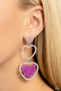 A light rose-encrusted silver heart, white rhinestone-encrusted silver heart frame, and fuchsia rhinestone-encrusted layered heart frame gradually increase in size as they delicately interconnect and stack into a dazzling lure for an elegant effervescence. Earring attaches to a standard post fitting.  Sold as one pair of post earrings.