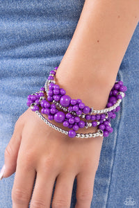 <p>Strands of sleek silver beads and accents mixed with plum acrylic beads in varying sizes are threaded along an infinity wrap-style bracelet. Clusters of beads are sporadically infused along the design, creating cloud-like, ethereal layers around the wrist.</p> <p><i> Sold as one individual bracelet.</i></p>