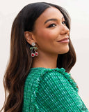 Embedded in glittery white rhinestones, various-shaped red and green rhinestones form two, vibrant cherries that swing from an exaggerated white gem post for a fantastic display of fruit. Earring attaches to a standard post fitting.  Sold as one pair of post earring