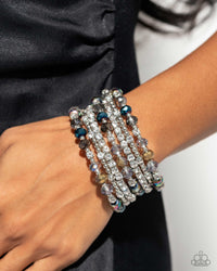 <p>Threaded along a coiled wire, silver beads, white rhinestones in silver square fittings, and oil spill, blue, silver, and transparent faceted beads curl around the wrist, creating an eye-catching, infinity wrap-style bracelet around the wrist.</p> <p><i> Sold as one individual bracelet.</i></p>